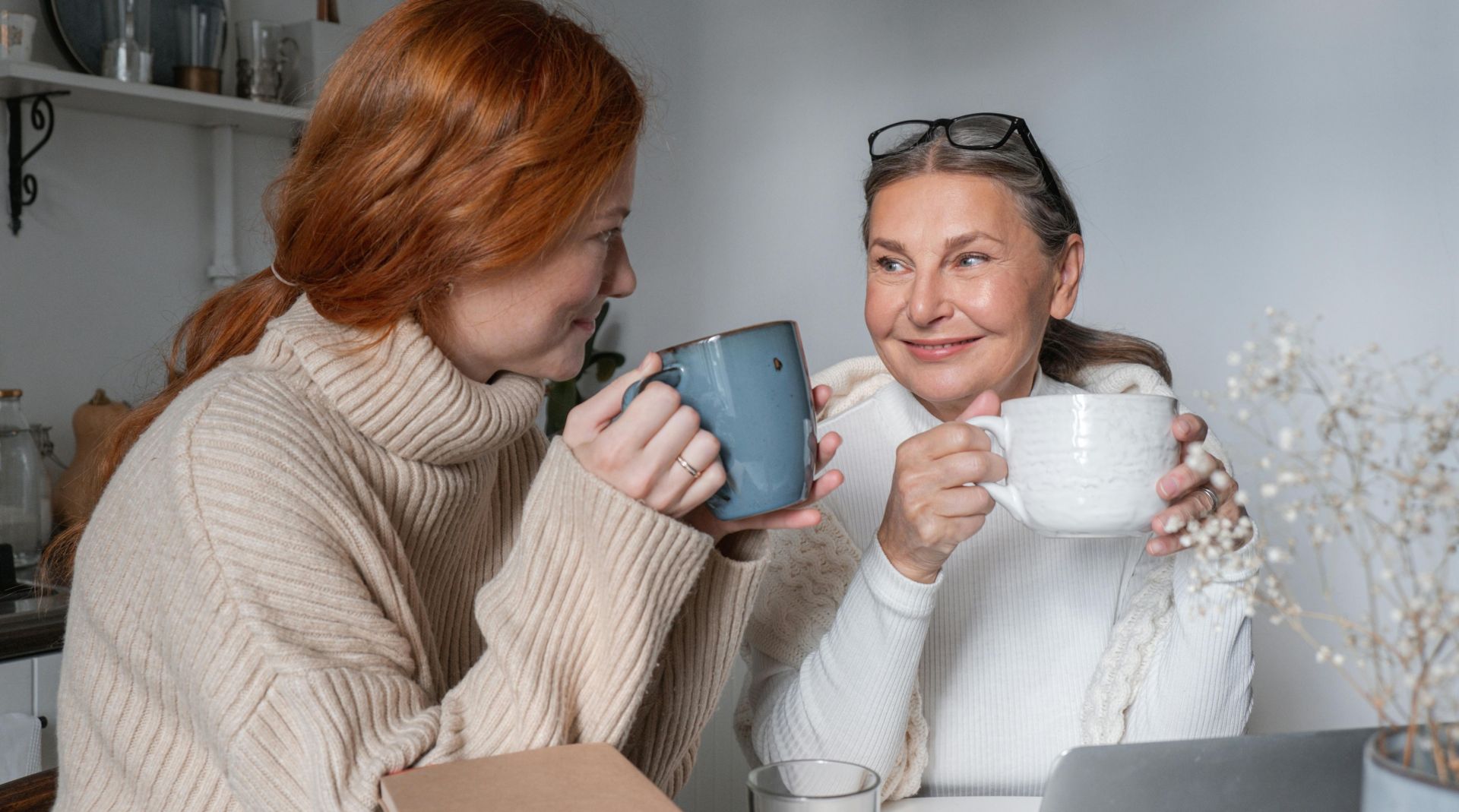 Women Sitting at a Table and Drinking Coffee Together