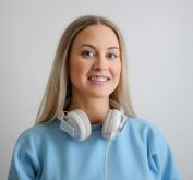 Woman in Blue Long Sleeve Shirt Wearing White Headphones