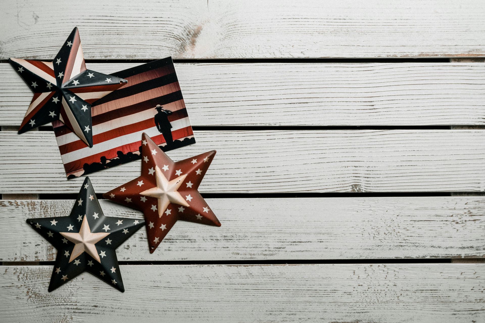 Patriotic stars on rustic wooden planks, showcasing American flag colors.